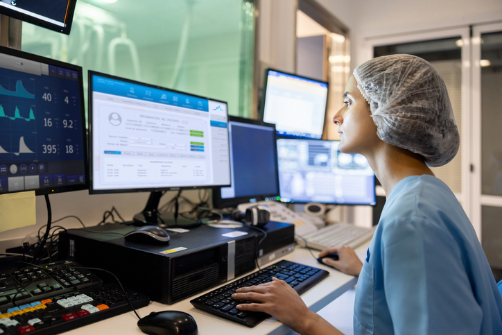 Doctor In The Control Room Looking At A Medical Scan