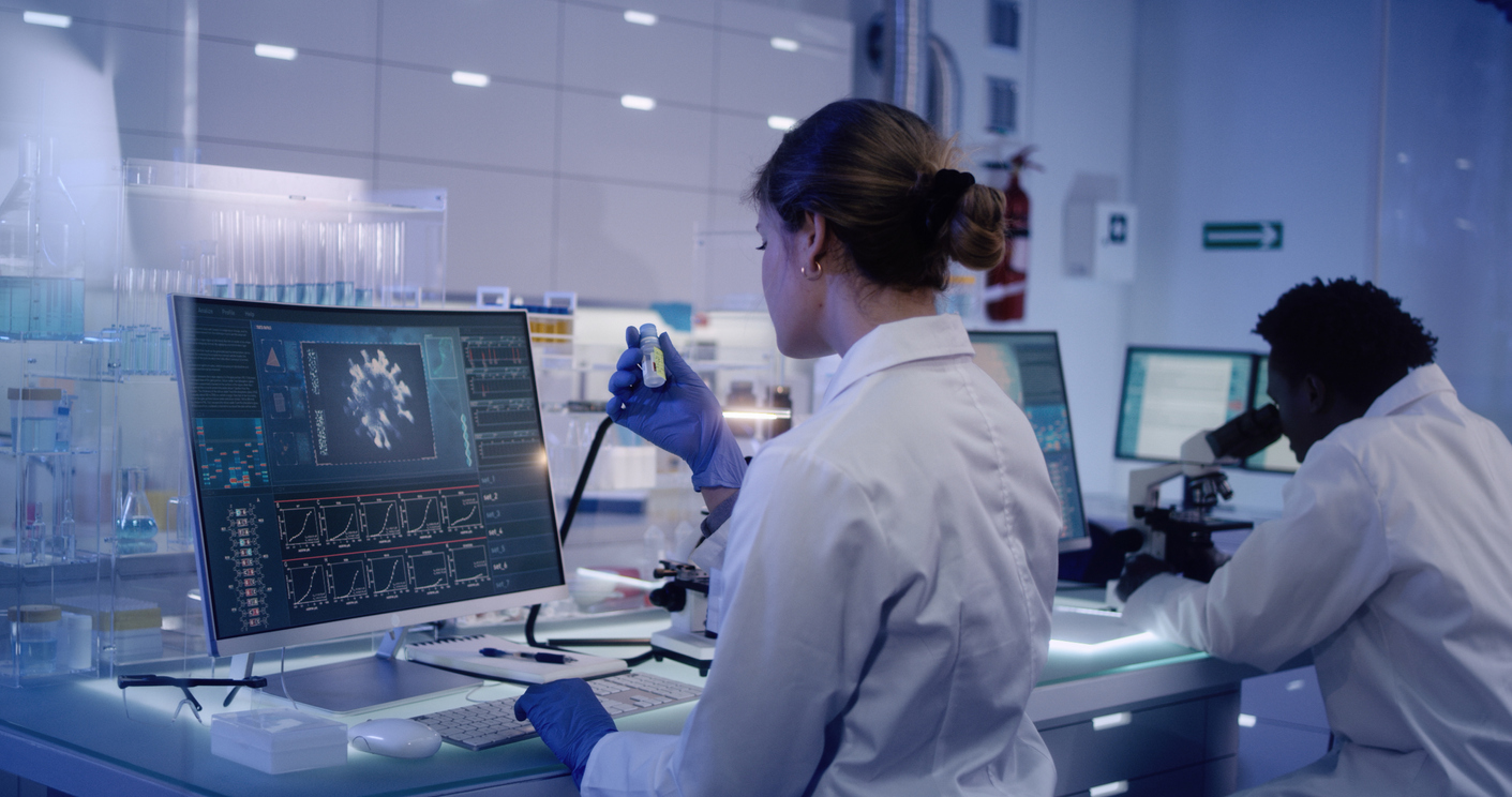 a woman and a man running rests and analyzing data in a medical laboratory