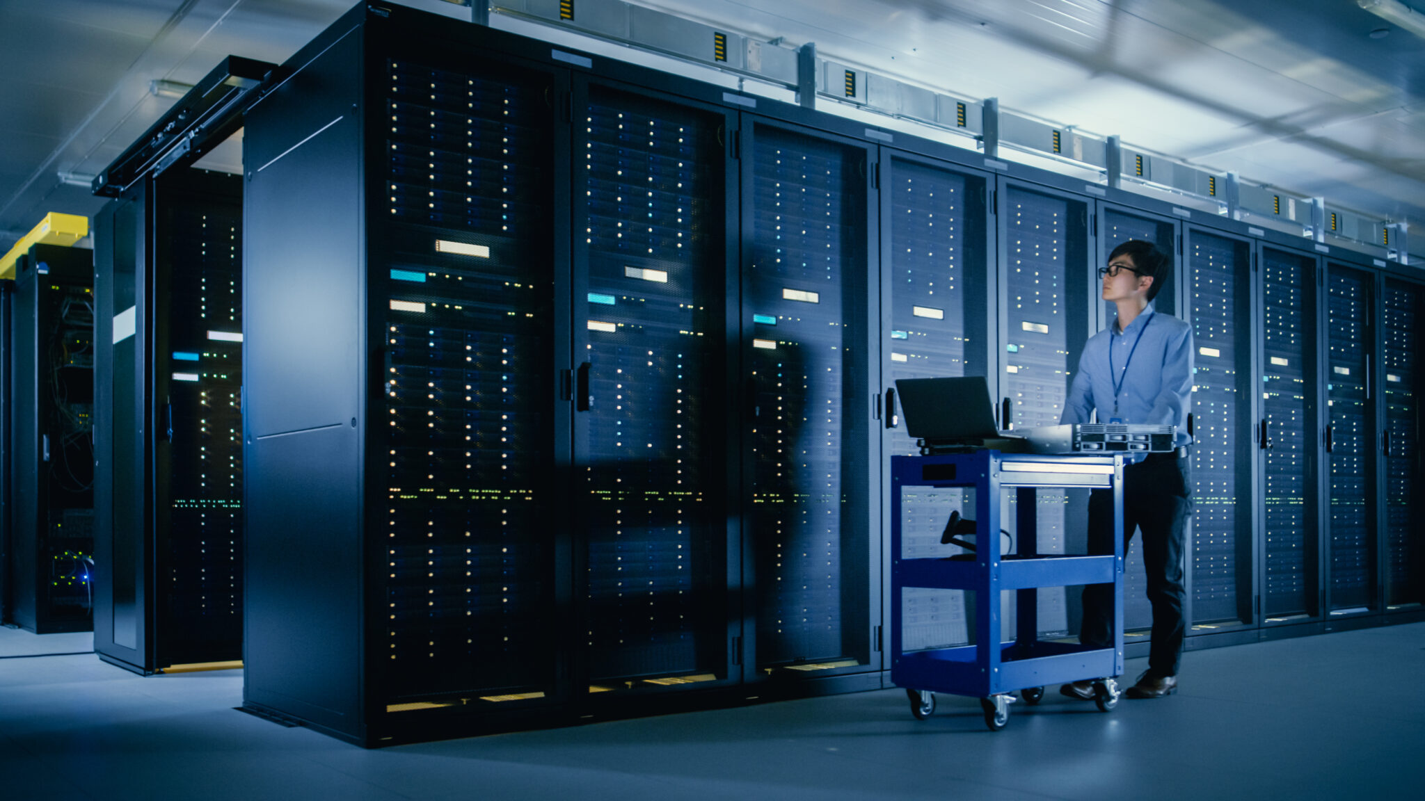 An IT administrator in a university data center monitoring IoT device activity and network security to ensure compliance with higher education cybersecurity regulations.