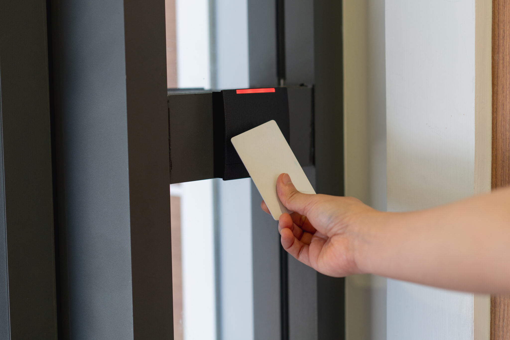 A smart keycard being used to access a secured campus building that uses an IoT-enabled access control system monitored and protected by Cylera’s risk management platform.