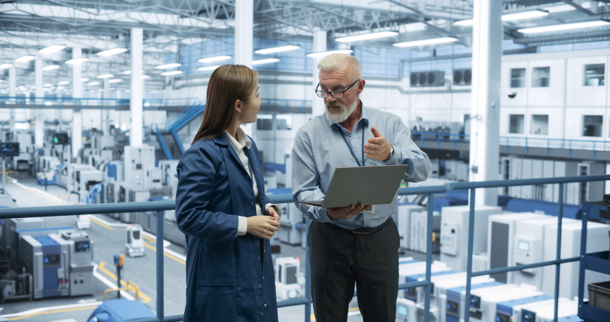 Manufacturing IT security analysts reviewing IoT device security data on Cylera’s platform to assess and mitigate attack surface risks in a smart factory.