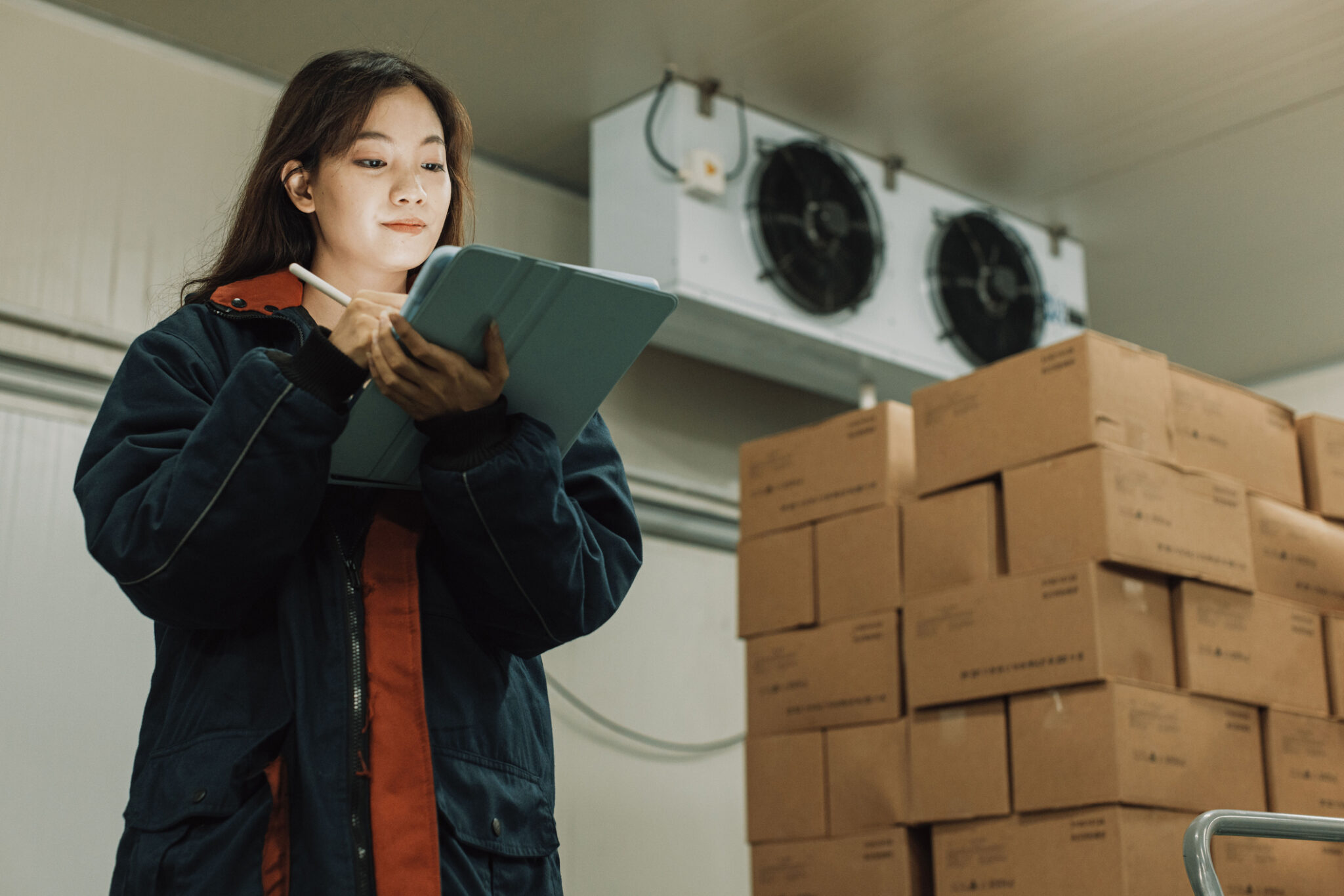 A manufacturing IT specialist using Cylera’s platform on a tablet to monitor IoT-connected environmental sensors, ensuring real-time security and operational efficiency.