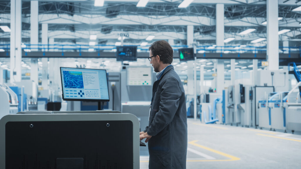 A manufacturing worker using several IoT connected circuit board printers that are all secured using Cylera’s platform, allowing the team to focus on critical production issues.