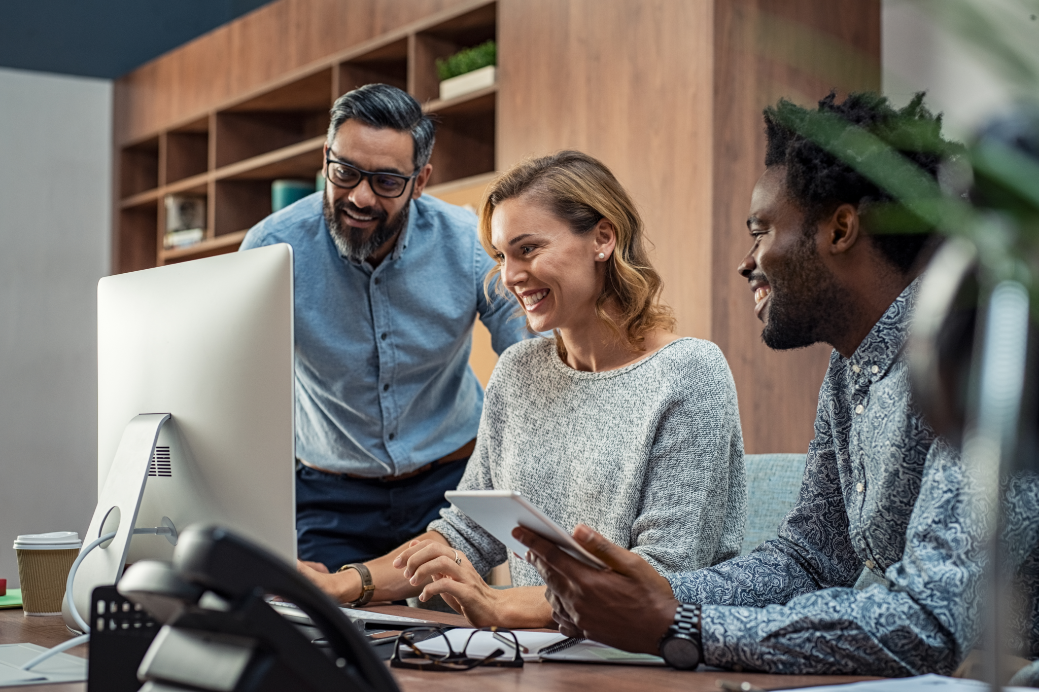 A transportation and logistics IT security team reviewing IoT device status, usage, and security metrics dashboards and reports provided by the Cylera platform on a laptop in real-time to identify ways to improve operational efficiency and security.