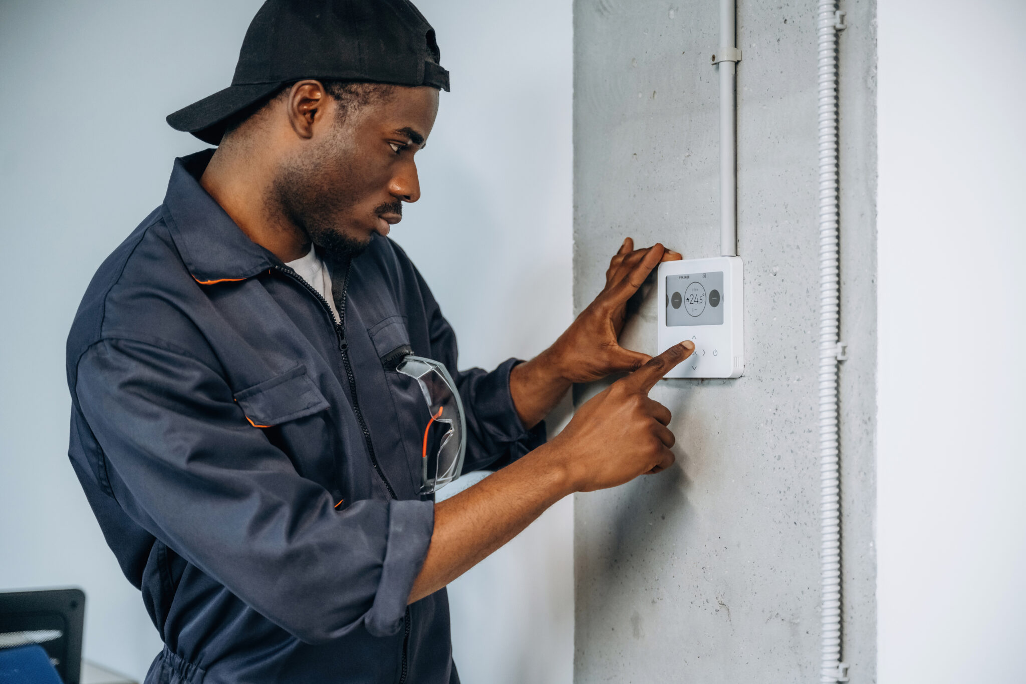 A transportation and logistics industry employee viewing a warehouse building management system IoT device smart sensor that the Cylera platform can discover and inventory to improve IoT device optimization and security.