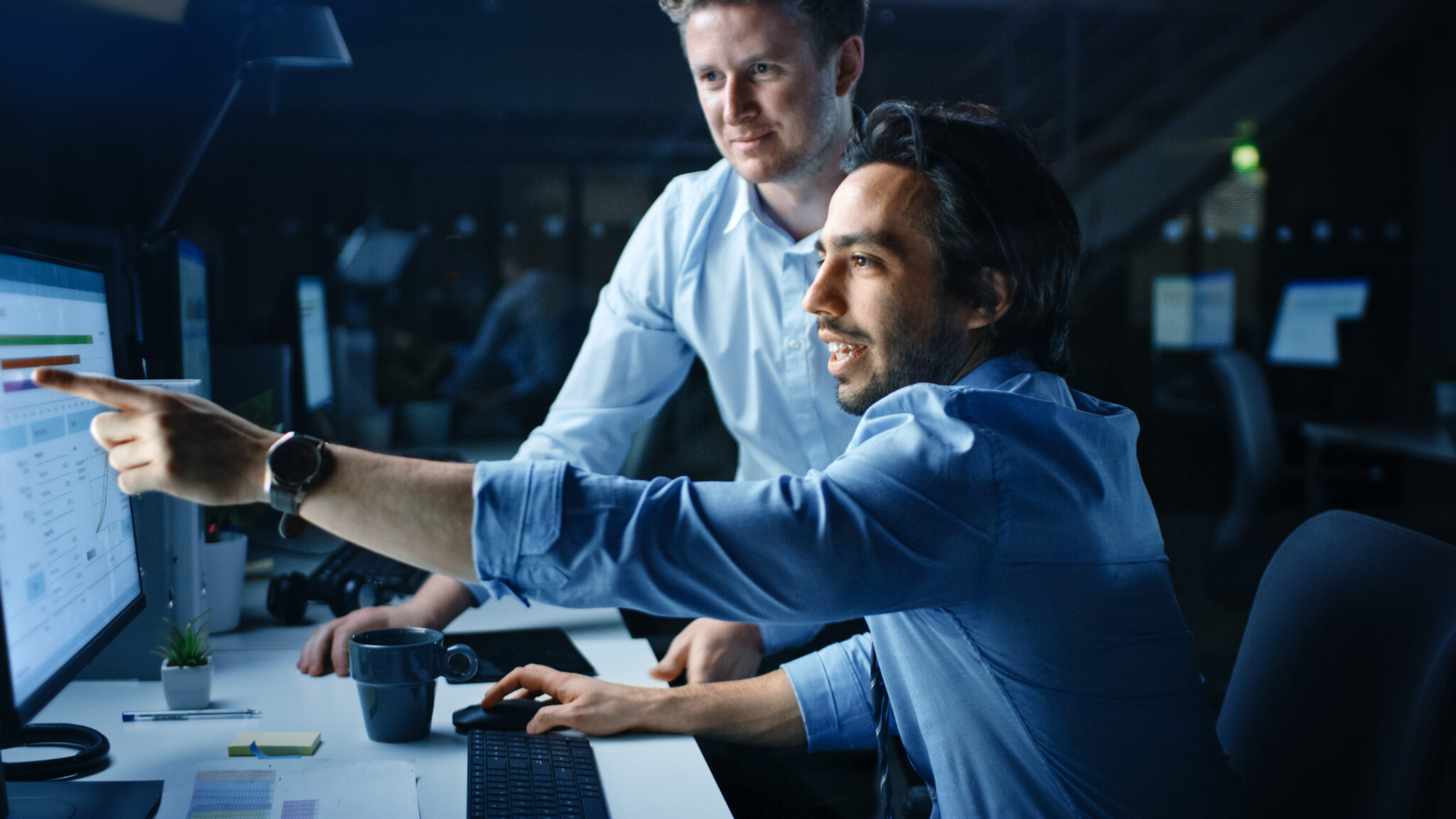 Transportation and logistics industry IT security employees viewing IoT device vulnerabilities, risks, and detailed vulnerability and risk remediation guidance provided by the Cylera platform on a computer monitor.